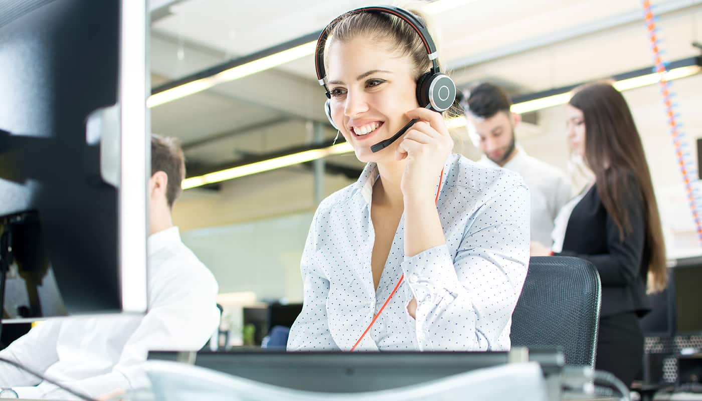 Smiling agent woman with headsets. Portrait of call center worker at office.