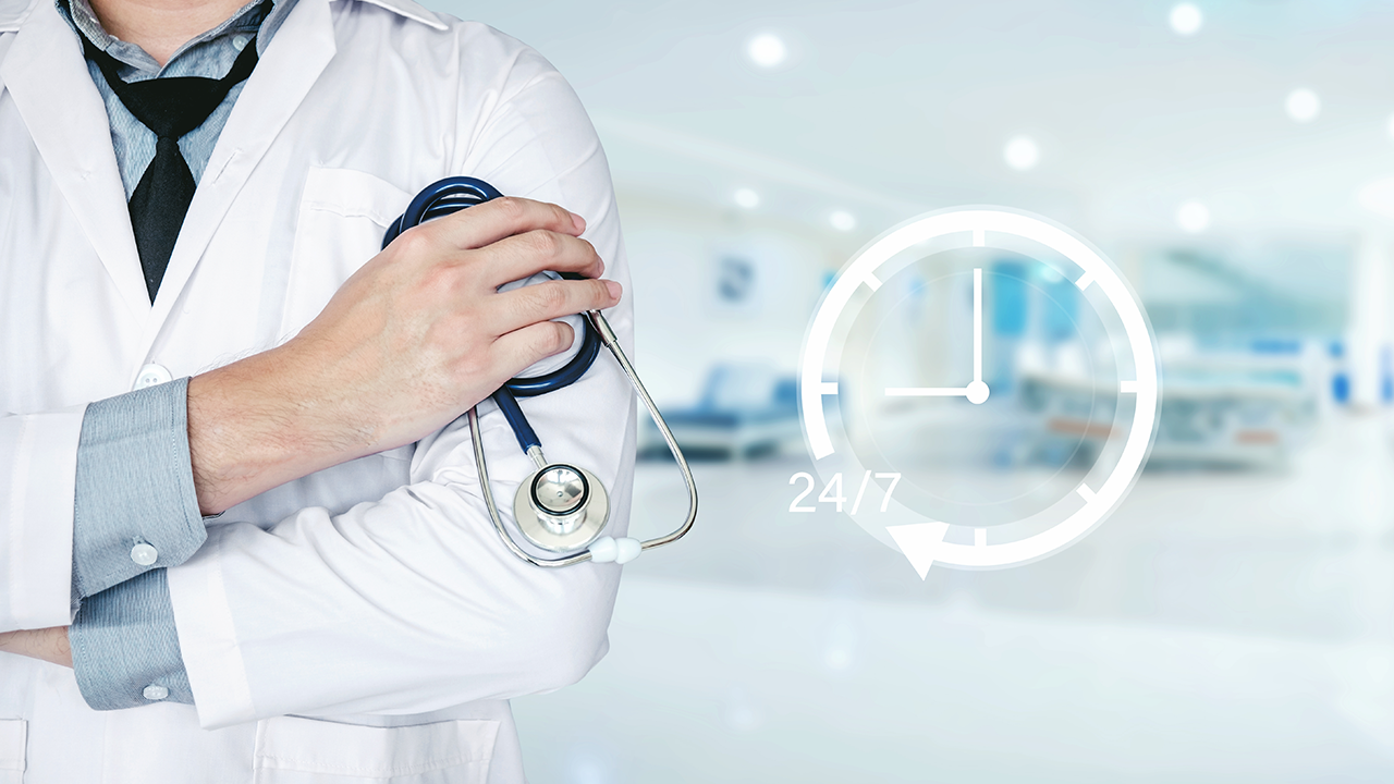 24/7 healthcare support concept with doctor holding stethoscope in hospital setting
