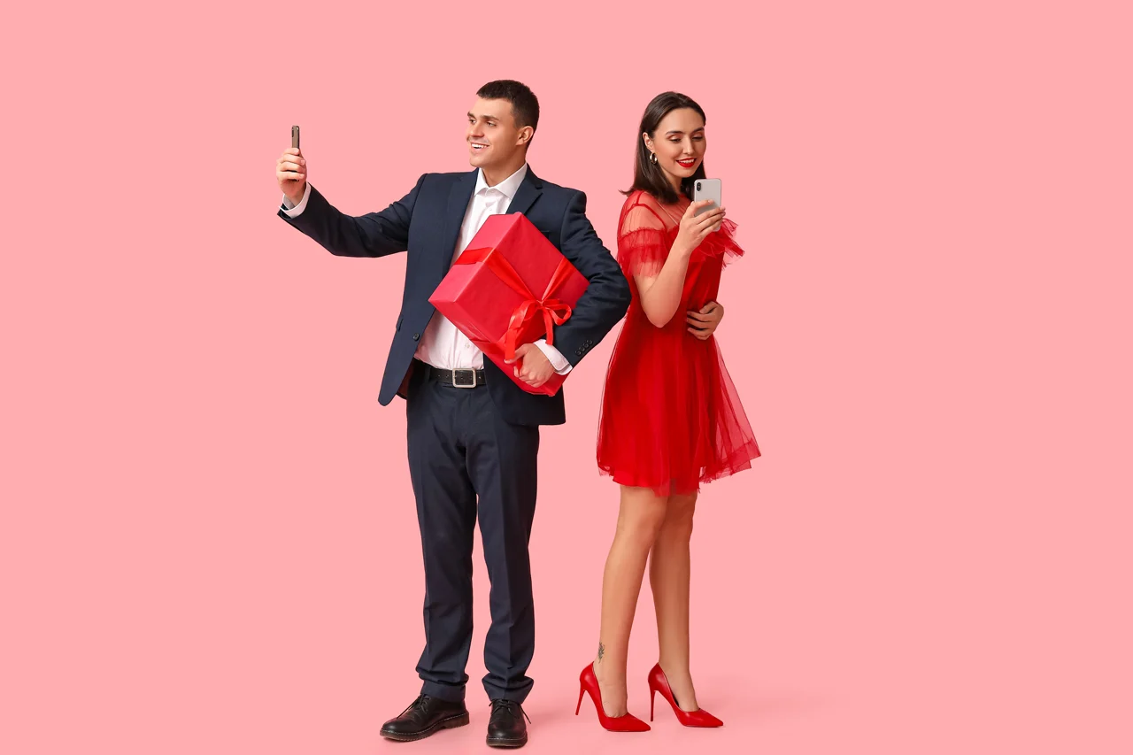 Couple posing with gifts and phones.