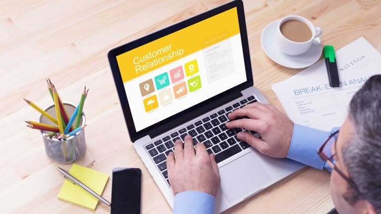 Working on a laptop with customer relations headiing