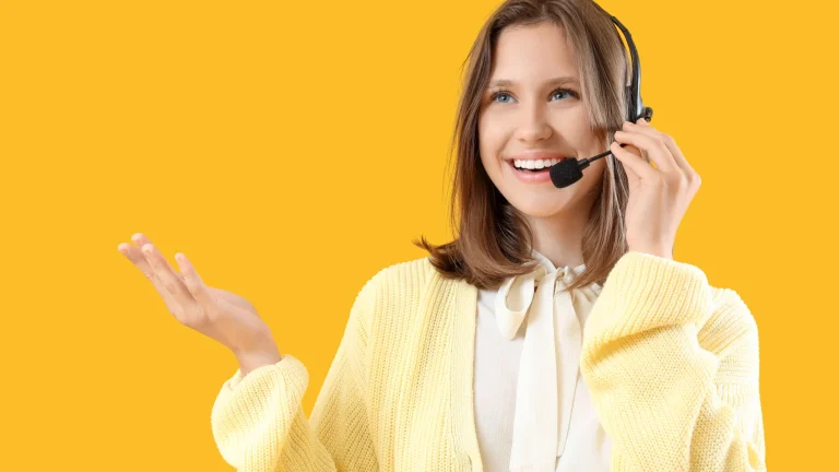 Smiling young woman wearing headset with microphone, customer service and communication concept, call center operator