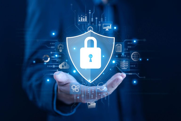 Cybersecurity concept with data protection shield and padlock icon over a businessman's hand, representing secure digital network, cloud security, and information privacy technologies.