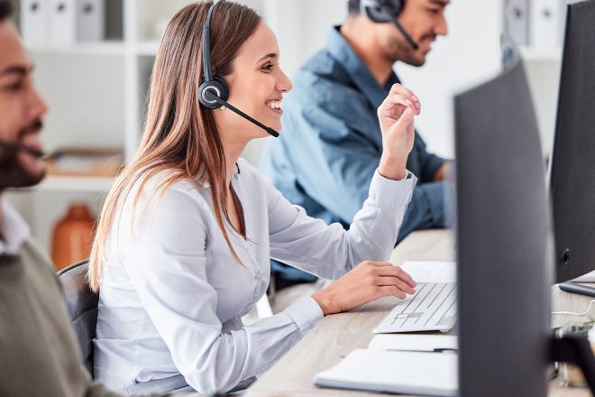 Cxperts Business Process Outsourcing (BPO) professionals working in a modern office environment smiling, collaborating on customer experience solutions