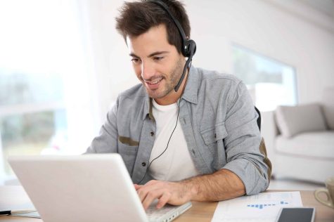 cxperts-Solutions_Salesjpg-scaled-1 (1) a man wearing a headset and using a laptop