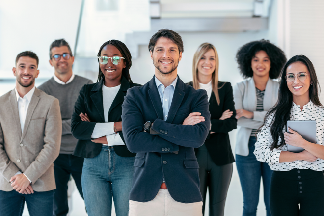 Confident business team standing together in a bright office, representing a unified approach to omnichannel retail customer experience and service delivery